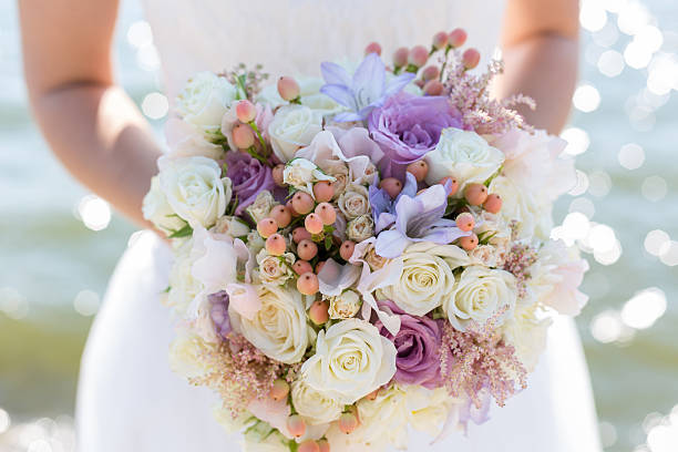 colour wedding bouquet in hands of the bride. Sacred Bloom