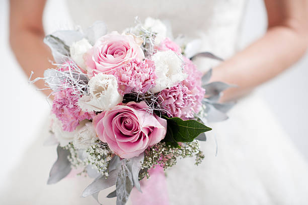 bride holding flower bouquet. Sacred Bloom